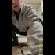 Miss Marilyn squats and holds a clear container of poop up to the camera, with more on the floor behind her. Presented in 720P vertical HD format. About half a minute.